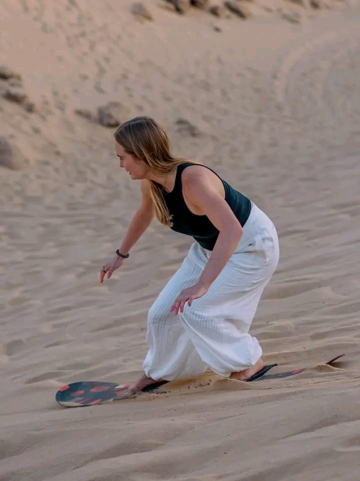 Sandboarding on the Timlalin dunes near Tamri, Morocco